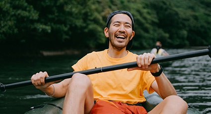 Young man smiling whilst canoeing